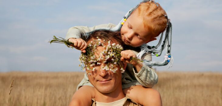 Dad and daughter. Man plays with little girl in nature